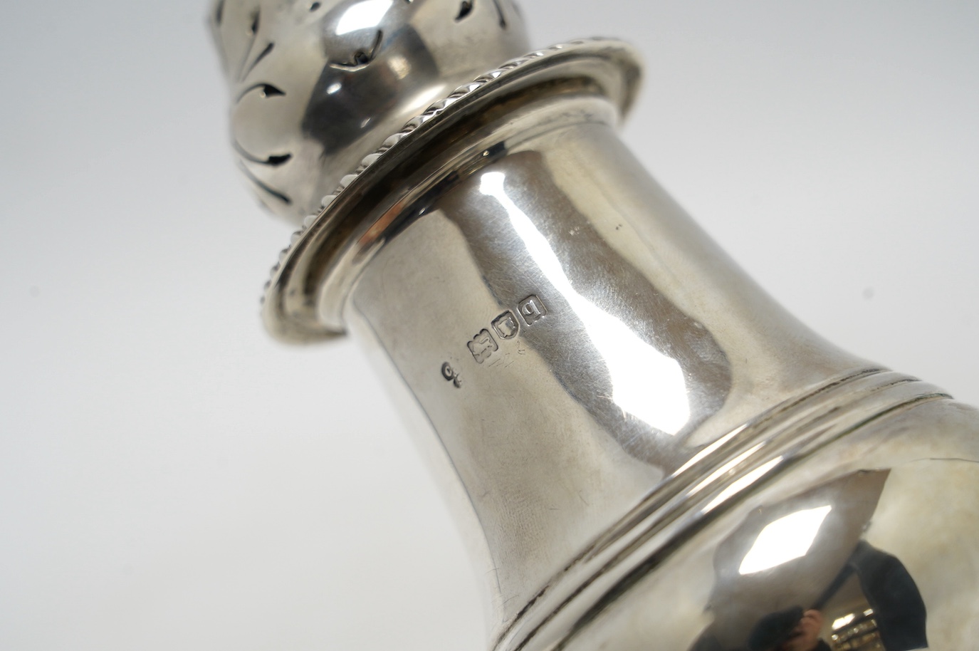A George V silver inverted pear shaped pedestal sugar caster, Charles Stuart Harris & Sons, London, 1911, 21.6cm, 6.5oz. Condition - fair